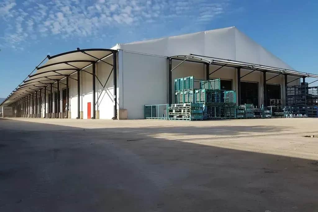 Sanayi sahasında kurulmuş büyük beyaz depo çadırı